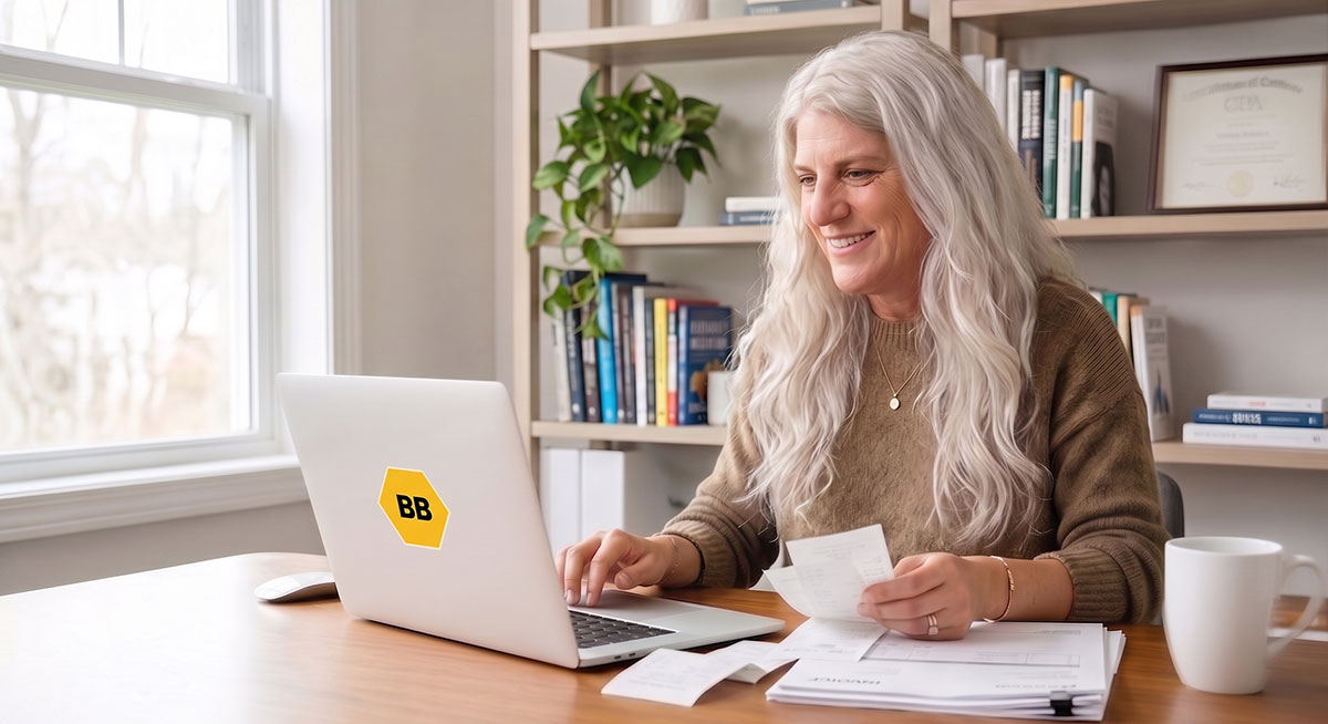 Leslie, founder of Bizzy Bee Bookkeeping, working with a small-business owner's books